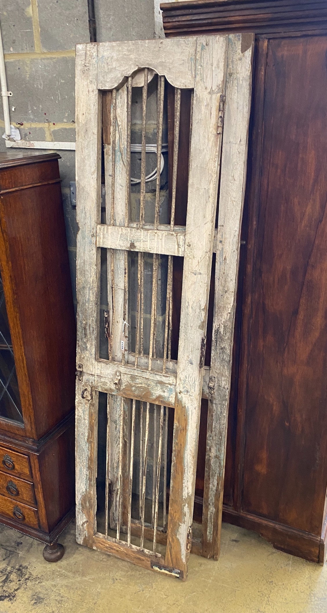 A pair of painted wood and wrought iron shutters, each width 48cm, height 184cm